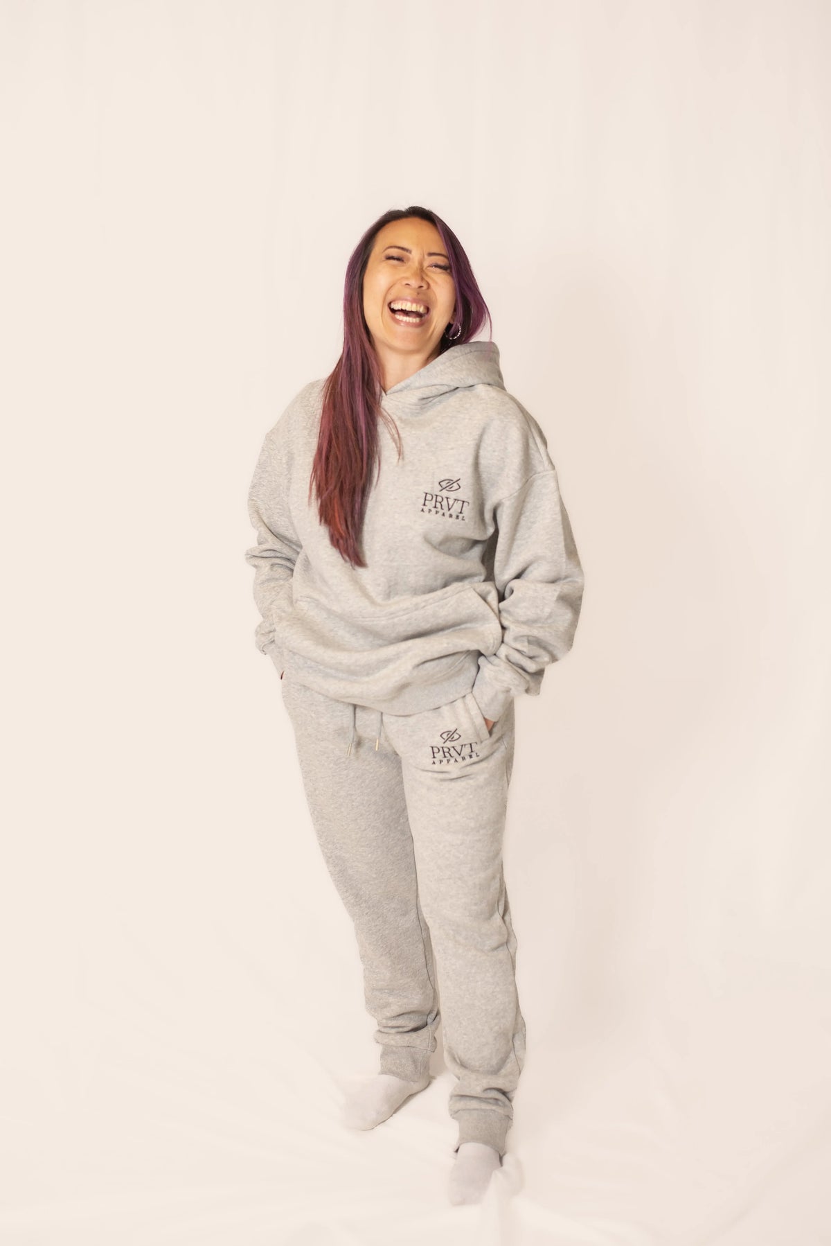 Soft black PRVT Apparel Inc. signature hoodie with front pocket and adjustable drawstrings, displayed on a hanger.