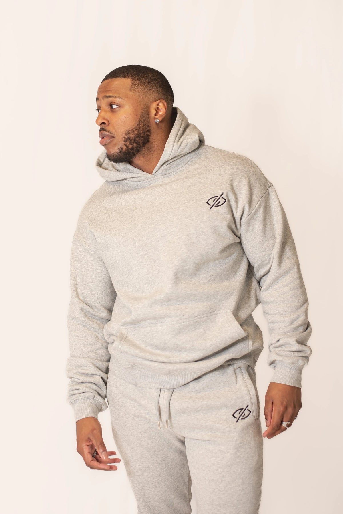 Soft gray classic sweats from PRVT Apparel Inc. with a relaxed fit, displayed on a hanger against a neutral background.