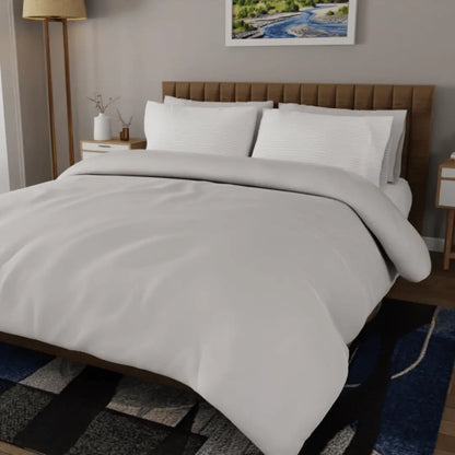 Luxurious organic percale sheets set by Skylark+Owl Canada, featuring crisp, breathable fabric in a cozy bedroom setting.
