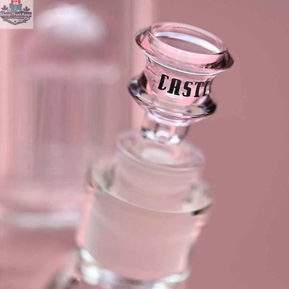 Close-up of a pink 8-arm beaker water pipe by Castle Glassworks, featuring a glass bowl and intricate design on a pink background.