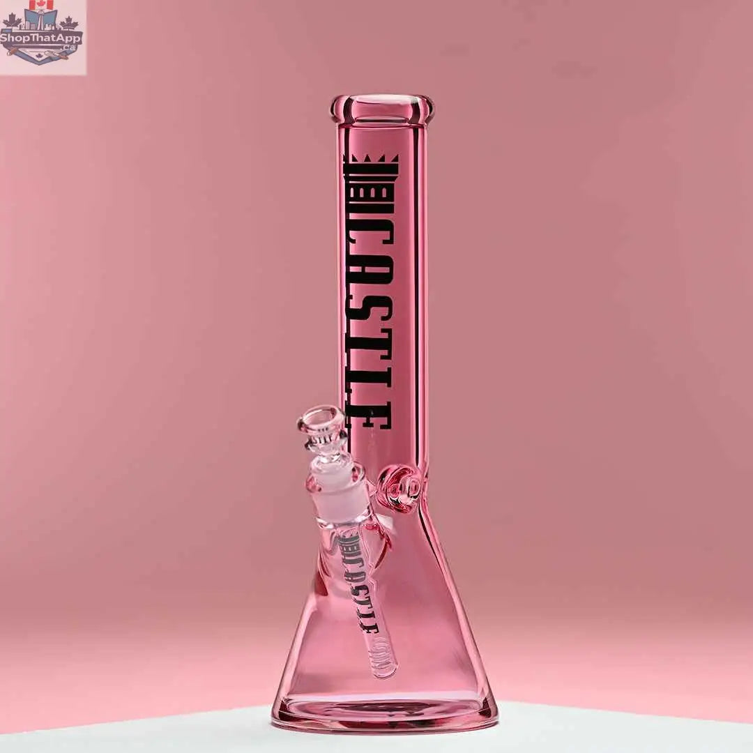 Pink 14-inch beaker bong by Castle Glassworks with heavy-duty 7mm electroplated glass, displayed against a pink background.
