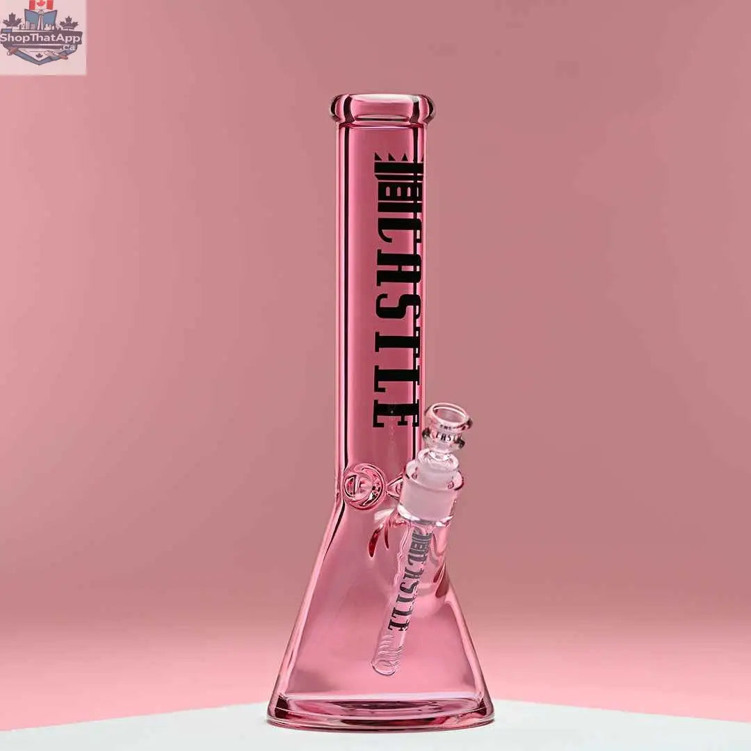 Pink 14-inch beaker bong by Castle Glassworks with heavy-duty electroplated glass on a pink background.