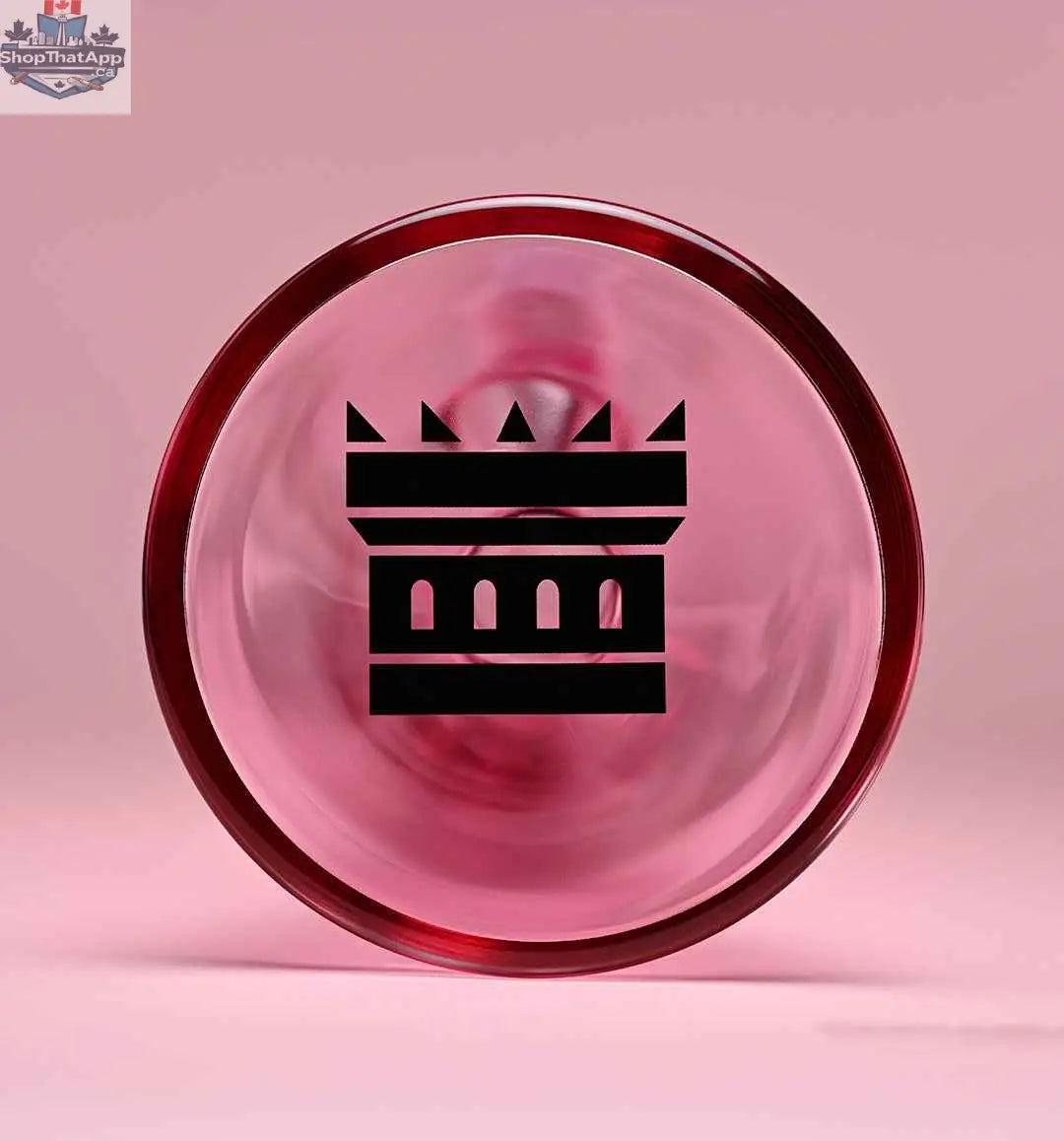 Close-up of a pink 14-inch beaker bong by Castle Glassworks with electroplated glass and a pink background, showing the base detail.