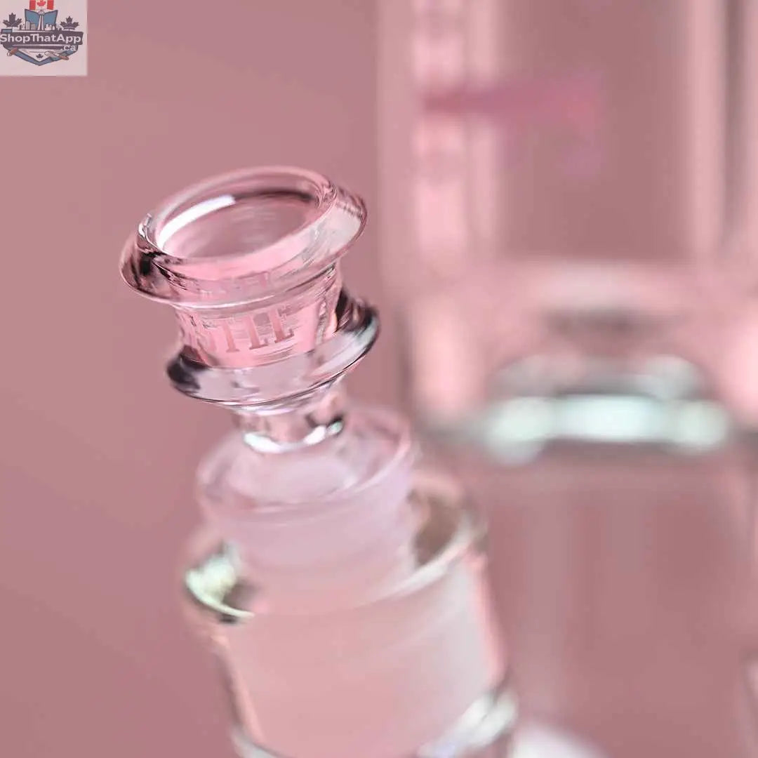 Castle Glassworks 14-inch beaker bong with pink logo and 9-hole downstem, shown with a pink background and close-up of the bowl.