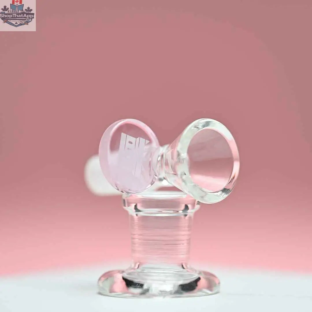 Pink 14mm borosilicate glass bowl with round tab handle by Castle Glassworks, shown on pink background from the left side.