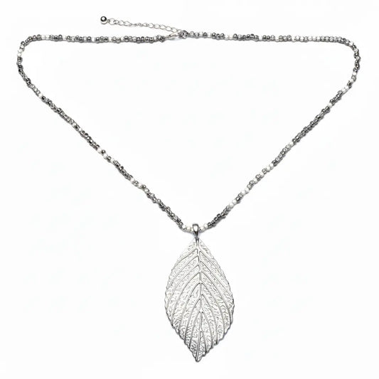 Silver leaf necklace on cube chain by Suzie Blue Canada, showcasing a delicate silver pendant with a sleek chain.