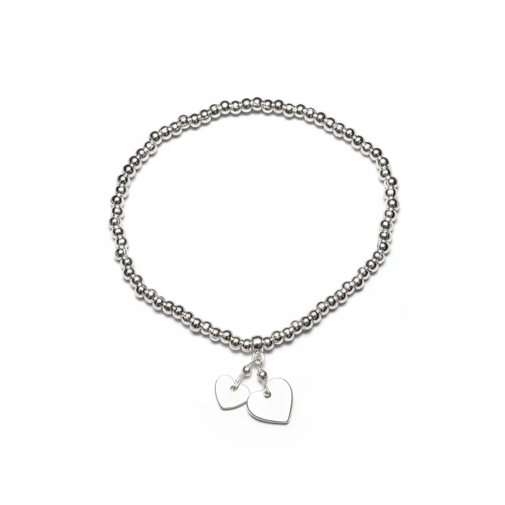 Silver heart charm bracelet by Suzie Blue Canada featuring elegant, timeless jewelry design with heart-shaped charms.