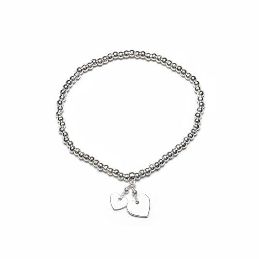 Silver heart charm bracelet by Suzie Blue Canada featuring elegant, timeless jewelry design with heart-shaped charms.