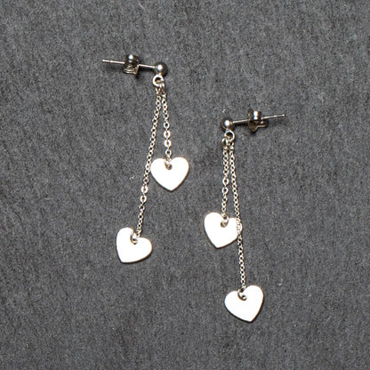 Silver plated double drop heart chain earrings by Suzie Blue Canada featuring layered heart design and elegant chain links.