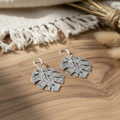 Hammered silver leaf earrings by Suzie Blue Canada featuring a silver plated, textured leaf design on elegant dangle earrings.