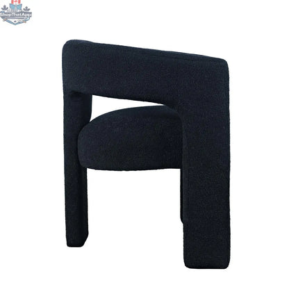 Sven upholstered dining chair in black bouclé fabric with wooden legs, side view, by Hygge Design House