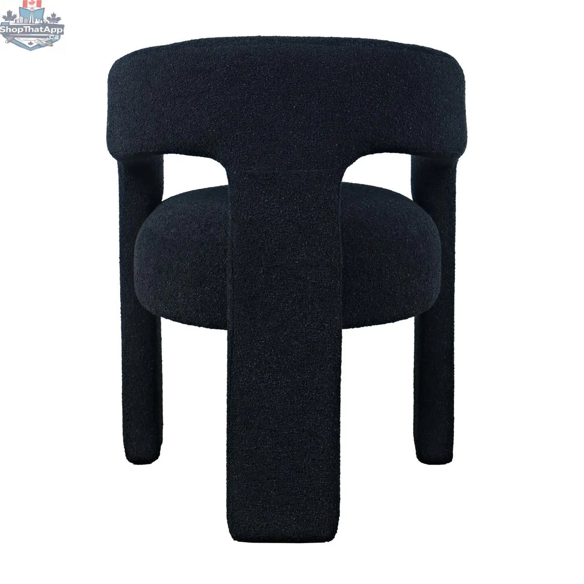 Sven upholstered dining chair in black bouclé fabric with wooden legs, shown from the back, by Hygge Design House.