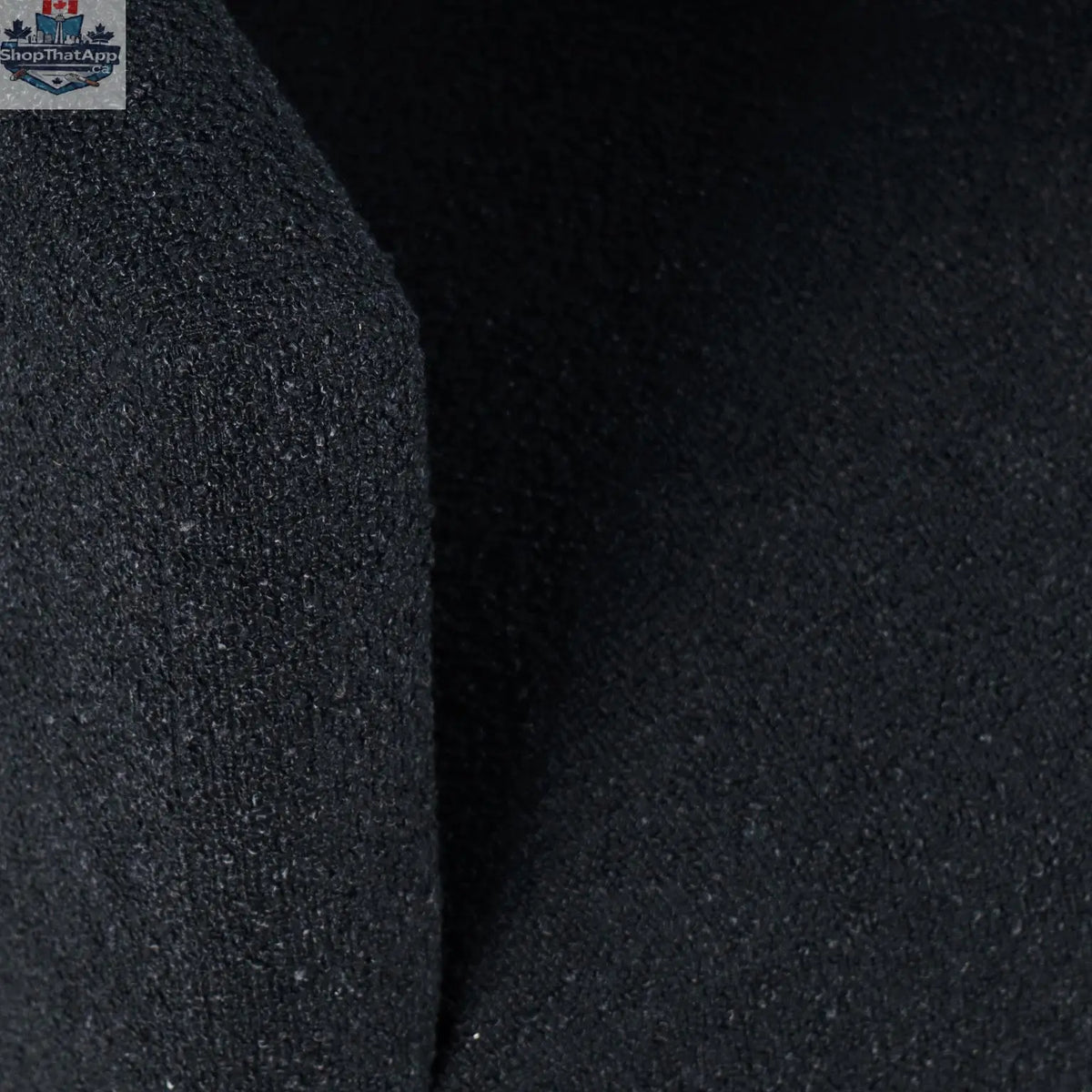 Sven upholstered dining chair in black bouclé fabric with a modern design, featuring a cushioned seat and wooden legs.