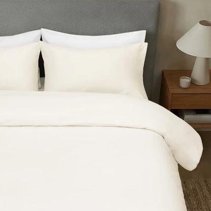 Chalk-colored Skylark+Owl Canada sateen duvet cover with smooth, elegant fabric for a refined bedroom look.