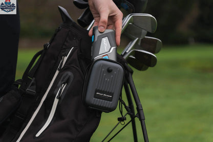 Golf rangefinder by The Golfather Ltd. with black and orange design, displaying a digital screen and measurement markings.