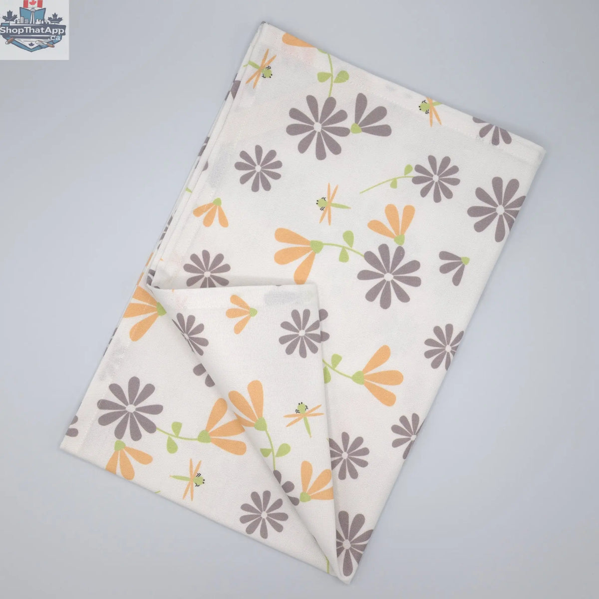 Printed Shy Dragonfly kitchen tea towels by Hem And Tassel, folded flat, featuring dragonfly design in grey and buff colors.
