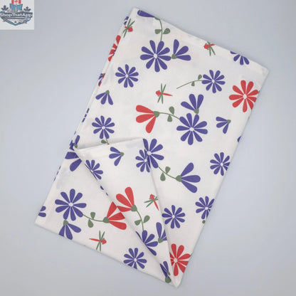 Printed purple and pink Shy Dragonfly tea towel from Hem And Tassel, folded to show the intricate dragonfly design.