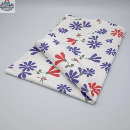 Printed purple and pink Shy Dragonfly tea towel from Hem and Tassel, folded to showcase the colorful dragonfly design.