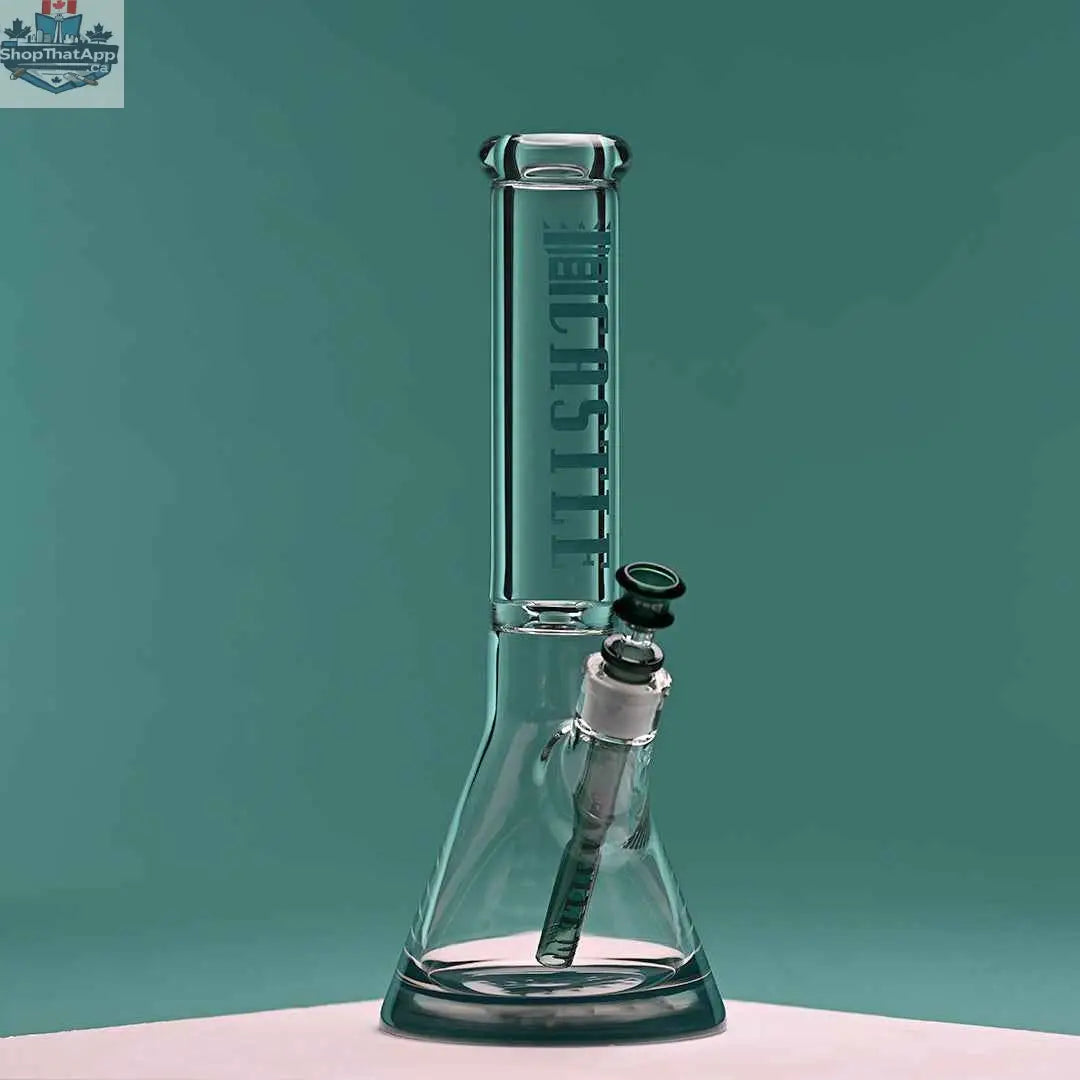 14-inch Castle Glassworks beaker bong with teal logo, clear glass, and a 9-hole downstem on a teal background.