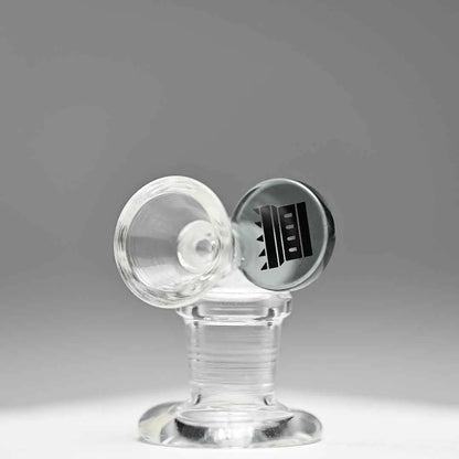Castle Glassworks 14mm borosilicate glass round tab bowl with transparent grey finish on a grey background.