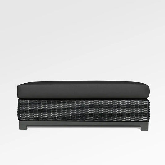 Enclover Trillium outdoor ottoman with Sunbrella Spectrum Carbon cushion, stylish and durable for outdoor seating and relaxation.