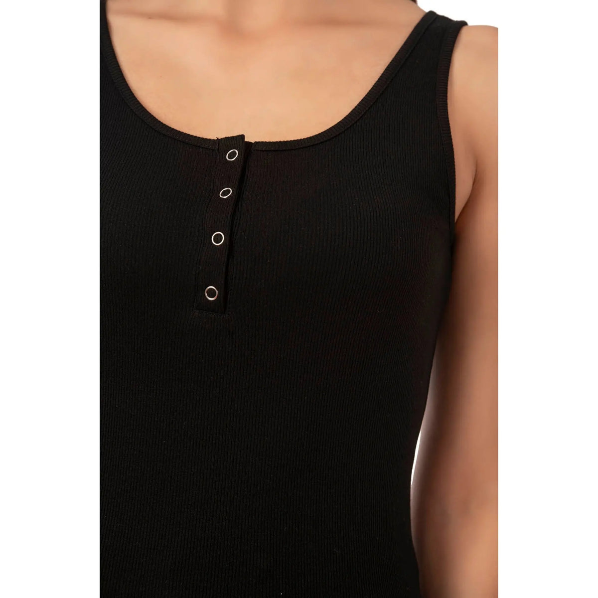 Women's ribbed cotton tank top with snap-button detail from Hazel Textile, showcasing a close-up of the fabric and button accents.