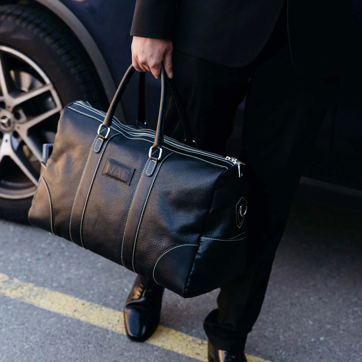 NAB Leather Cognac leather duffle bag with sturdy handles and a spacious main compartment, crafted in Canada.