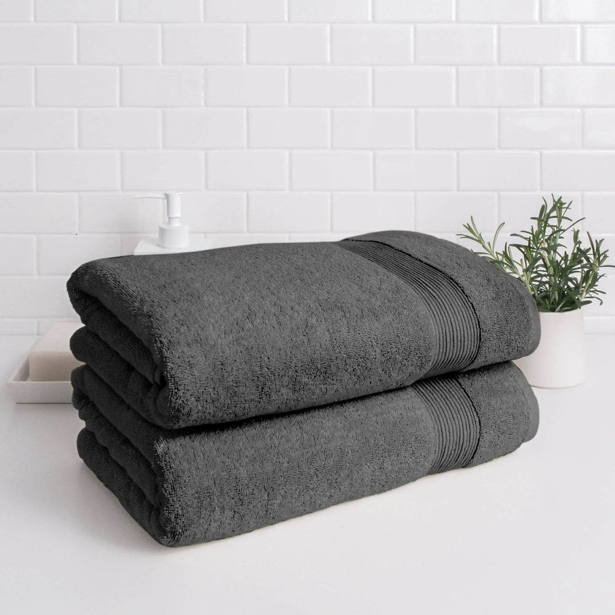 Stacked Essence Turkish bath towels by Skylark+Owl Canada in charcoal, showcasing their luxurious, absorbent bath sheet design.
