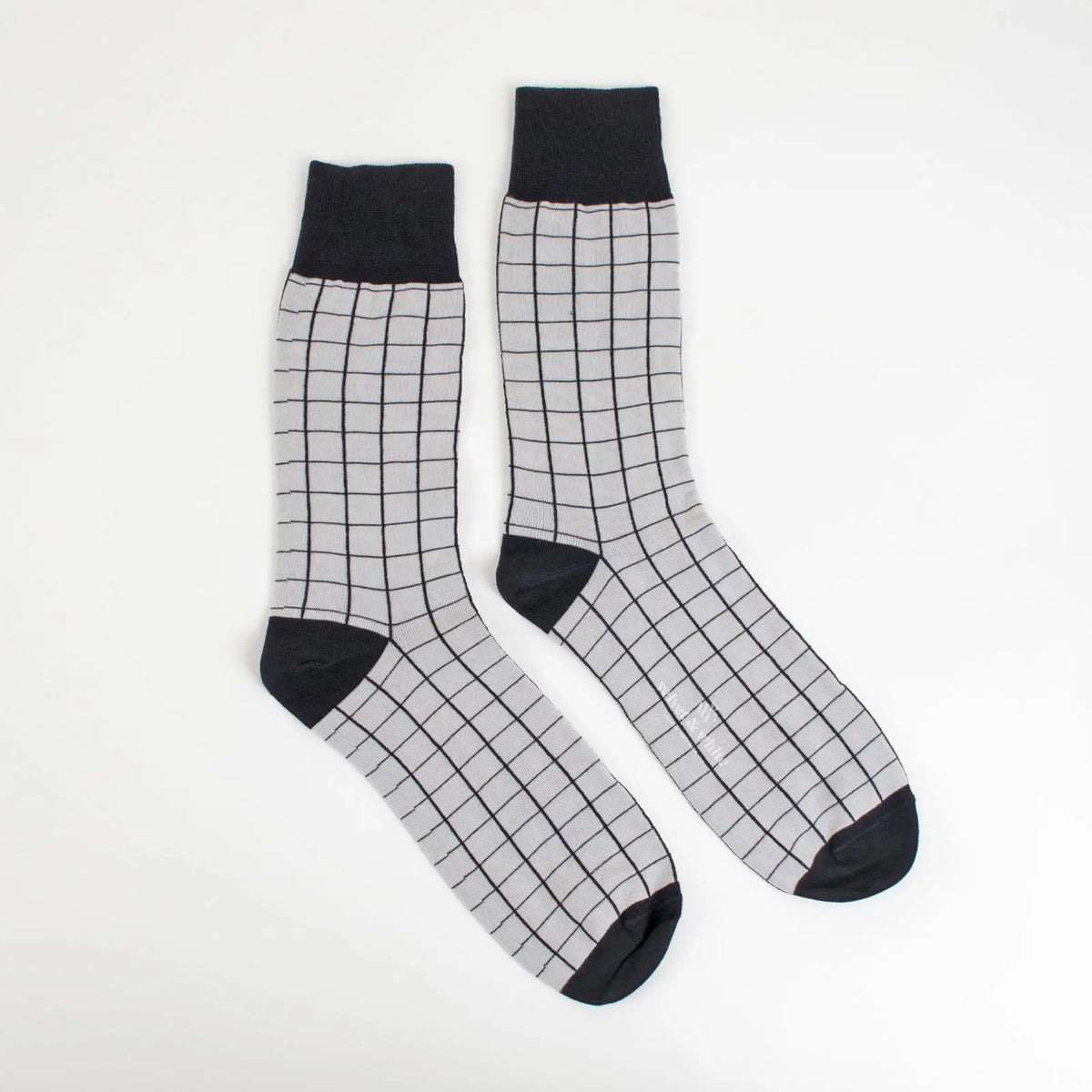Black and grey Velvet and White socks with striped patterns, displayed in a close-up view.