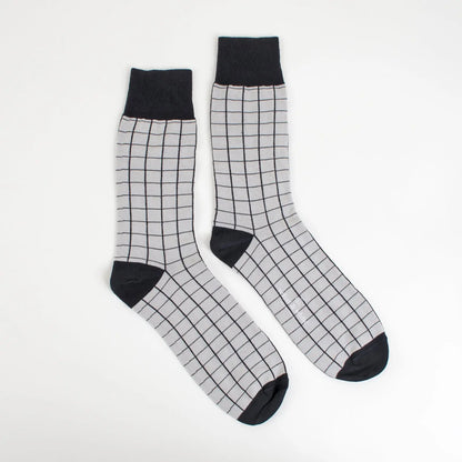 Black and grey Velvet and White socks with striped patterns, displayed in a close-up view.