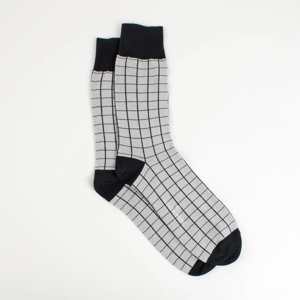 Black and grey Velvet and White socks with a striped pattern, displayed on a plain background.
