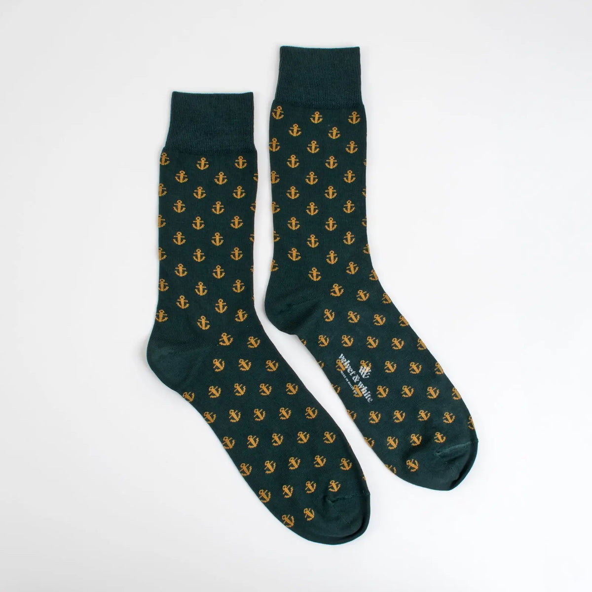 Pair of green nautical-themed socks from Velvet and White with anchor patterns, ideal for nautical-inspired home decor.