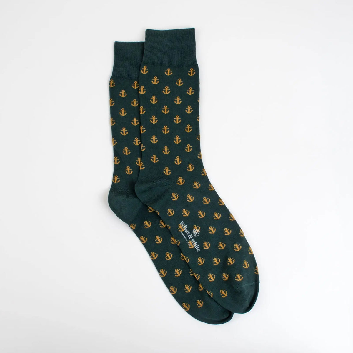 Green nautical-themed socks by Velvet and White featuring anchor designs, perfect for nautical-inspired home decor.