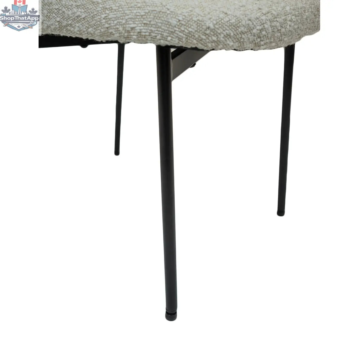 Hygge Design House Sashi Linen Boucle Dining Chair with sleek wooden legs and modern, textured upholstery.