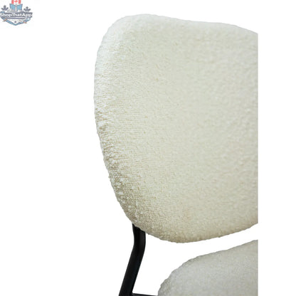 Hygge Design House Sashi dining chair with linen boucle upholstery, modern design, and wooden legs.