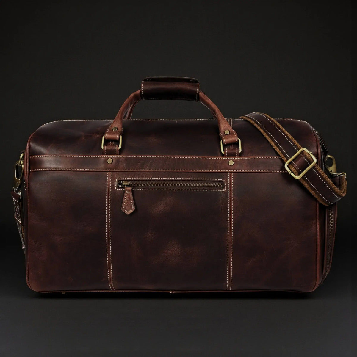 Brown leather duffle bag from NAB Leather's Voyager collection, full-grain distressed leather with sturdy handles and spacious interior.