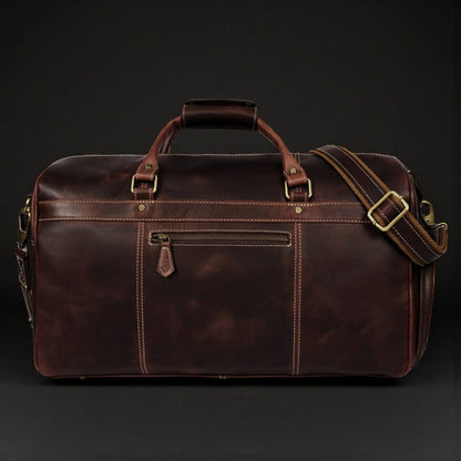 Brown leather duffle bag from NAB Leather's Voyager collection, full-grain distressed leather with sturdy handles and spacious interior.