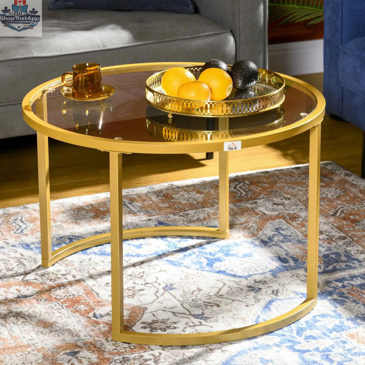 Set of two modern nesting coffee tables with gold finish and tempered glass tops by SLOTH Nation, stylish living room furniture.