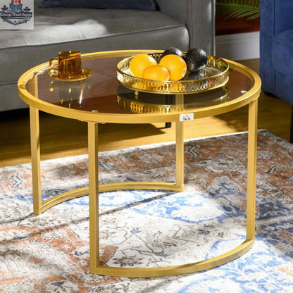 Set of two modern nesting coffee tables with gold finish and tempered glass tops by SLOTH Nation, stylish living room furniture.