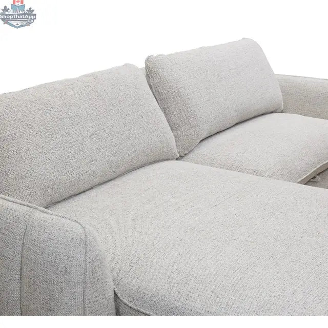 Amira pullout sleeper sectional with storage chaise by Hygge Design House, featuring stitched armrests and modern fabric upholstery.