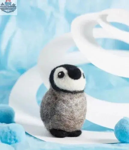 Hawthorn Handmade Baby Penguin Felting Kit by Art Noise showing a tiny, crafted baby penguin made from felting wool.