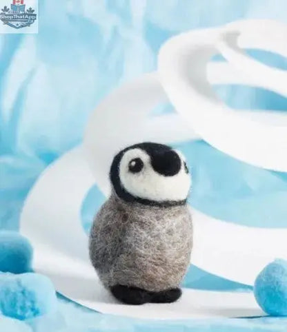 Hawthorn Handmade Baby Penguin Felting Kit by Art Noise showing a tiny, crafted baby penguin made from felting wool.