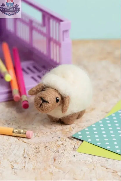 Hawthorn Needle Felting Kit by Art Noise featuring a handmade sheep mini felted figurine and felting tools on a neutral background.