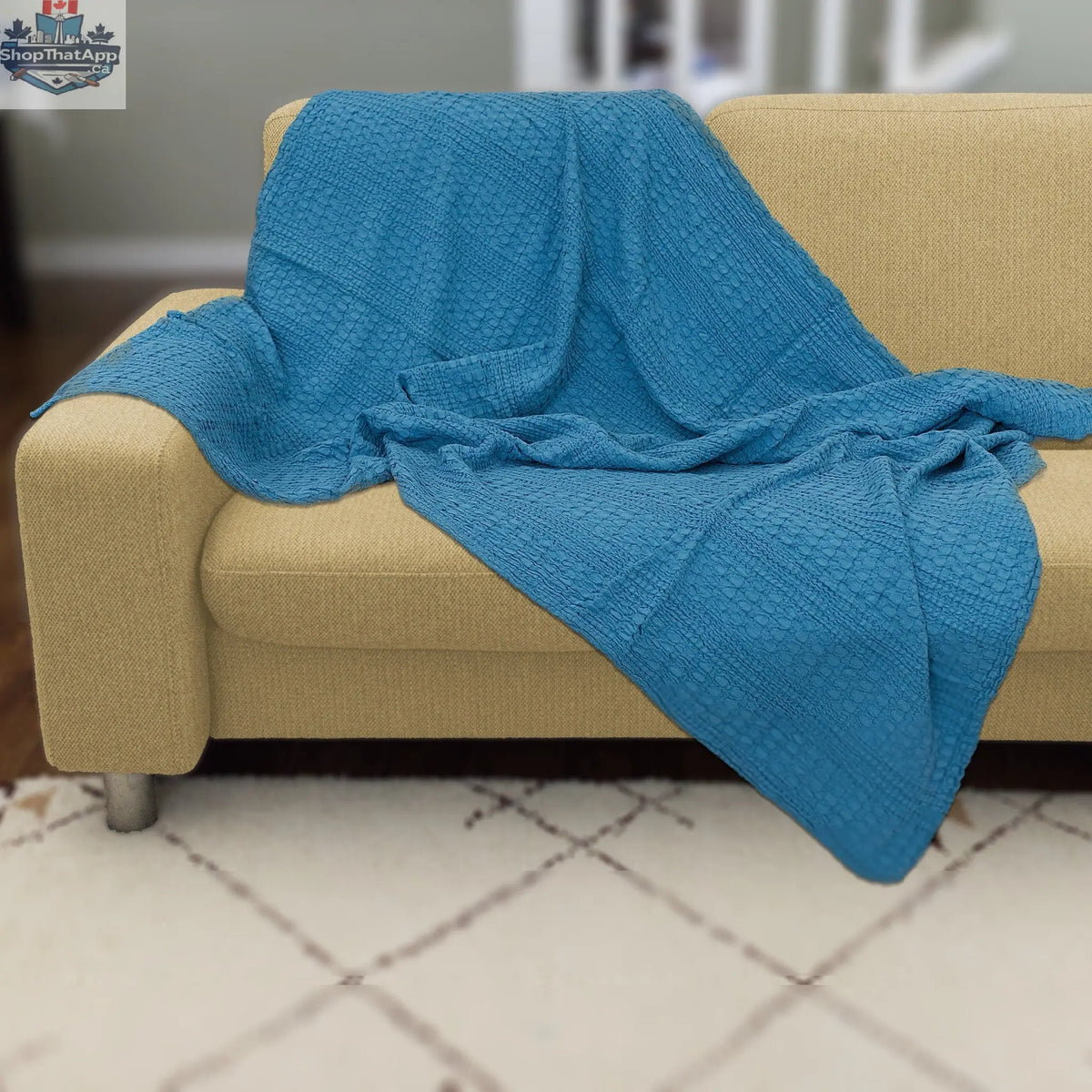 Blue double-waffle cotton throw blanket from Hem And Tassel draped over a sofa for cozy home decor.