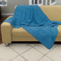 Blue double-waffle cotton throw blanket from Hem And Tassel draped over a sofa for cozy home decor.