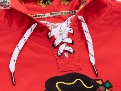 Black Chicago Blackhawks hoodie with lace design by Calhoun Surf N' Skate, featuring team logo and detailed fabric pattern.