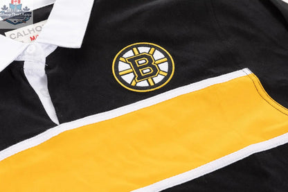 Close-up of a Boston Bruins rugby shirt by Calhoun Surf N' Skate, showing detailed team logo and fabric texture.