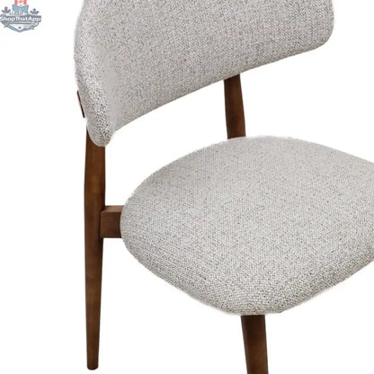 Beige fabric Cammy dining chair with walnut wood frame, showing the backrest and seat detail for Hygge Design House.