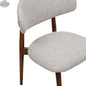 Beige fabric Cammy dining chair with walnut wood frame, showing the backrest and seat detail for Hygge Design House.