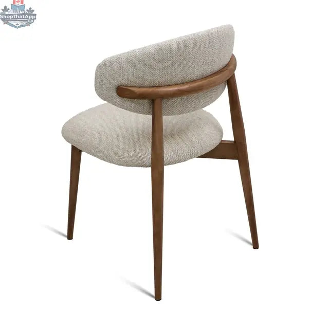 Beige fabric Cammy dining chair with walnut wood frame, shown from the back view, by Hygge Design House.